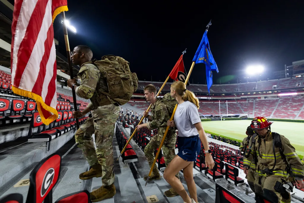 Left to right, Army ROTC cadets Hampton Jackson and Ryan Fagan along with Air Force ROTC cadet Mikayla Lachowicz carry the colors.