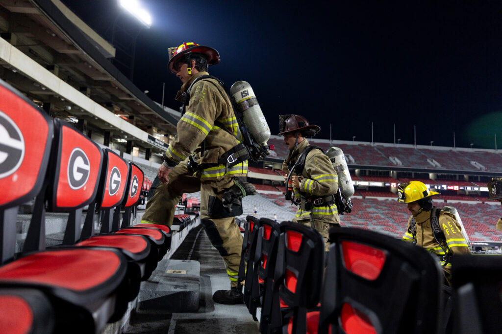 Jacob Jones, left, captain of the Athens Clarke County Fire Department leads firefighters during the 9/11 memorial stair climb.