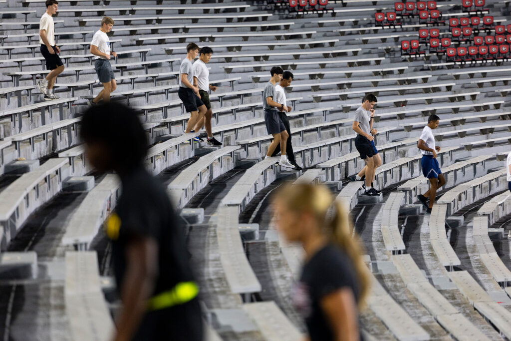 Air Force ROTC cadets walk up and down the stairs.