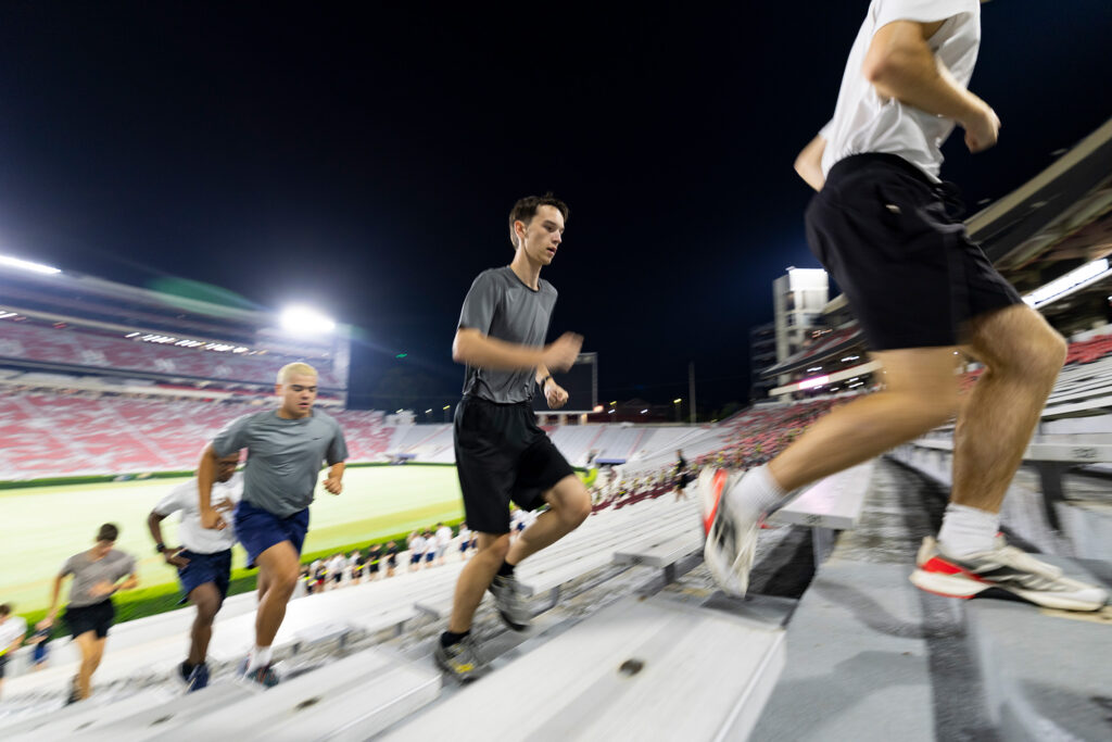 Air Force cadets run up the stairs.