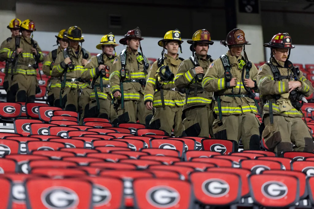 Athens-Clarke County firefighters walk down the stairs.