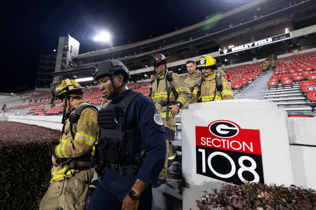Athens-Clarke County firefighters and UGA police officer walk down the steps.