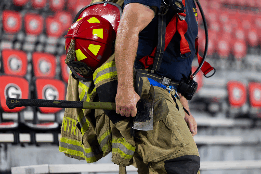 Oconee County firefighter Joseph Gentry carries an axe along with his gear.