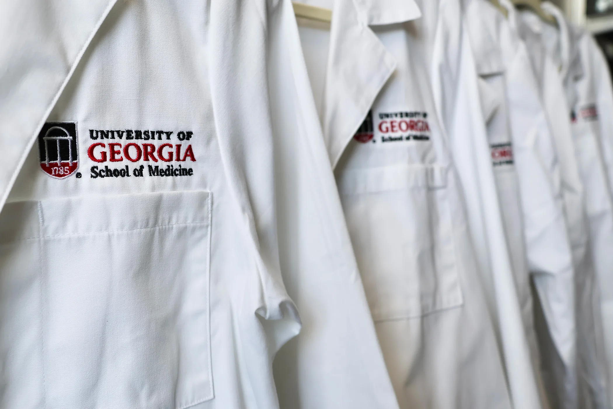 Close-up of UGA School of Medicine white coats. (Photo by Lindsey Derrick)