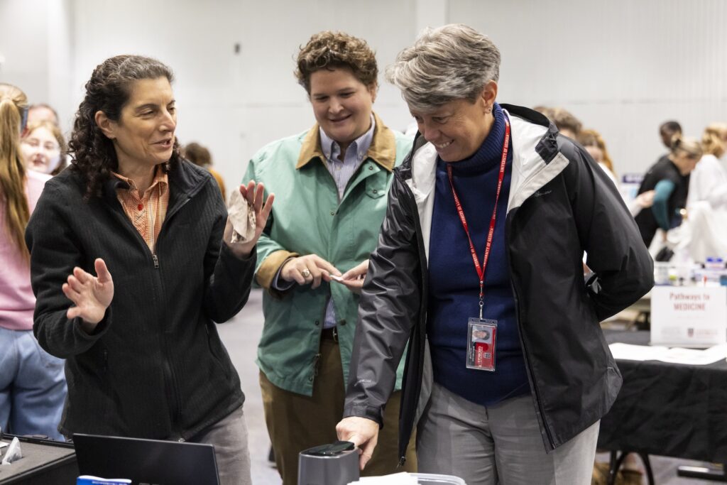 Dean Nuss scans her finger in the Veggie Meter to measure carotenoid levels in skin indicating recent fruit and vegetable intake.