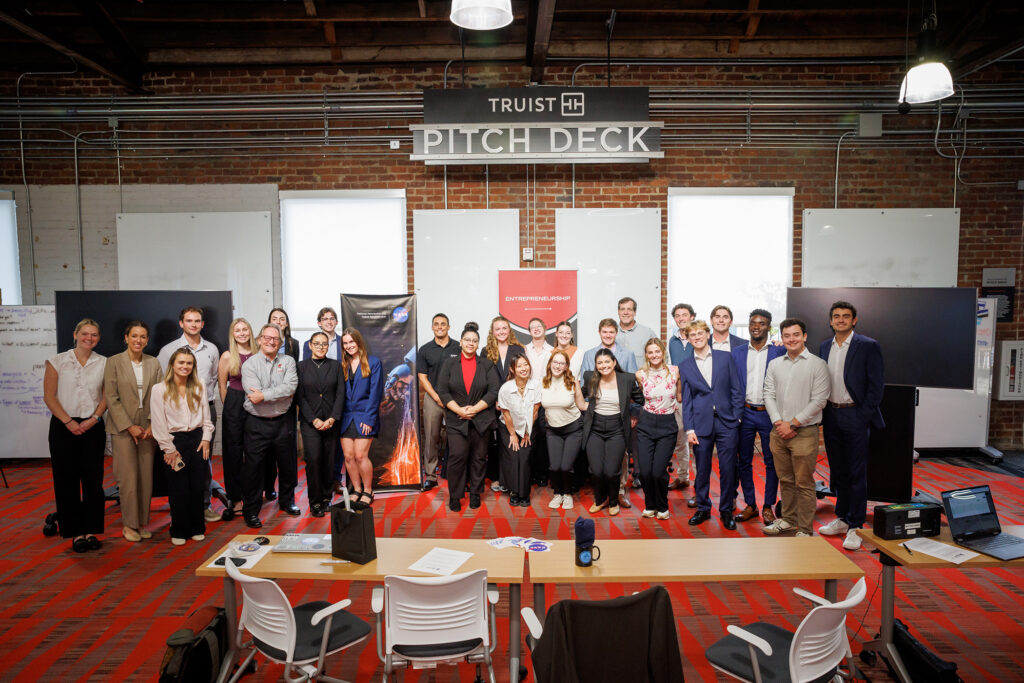 Group of people pose together in Truist Pitch Deck entrepreneurship workspace.
