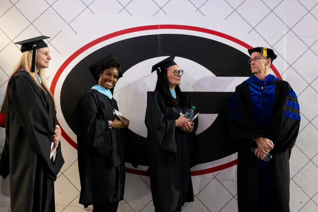 Graduates wait to be introduced at the fall graduate Commencement ceremony.