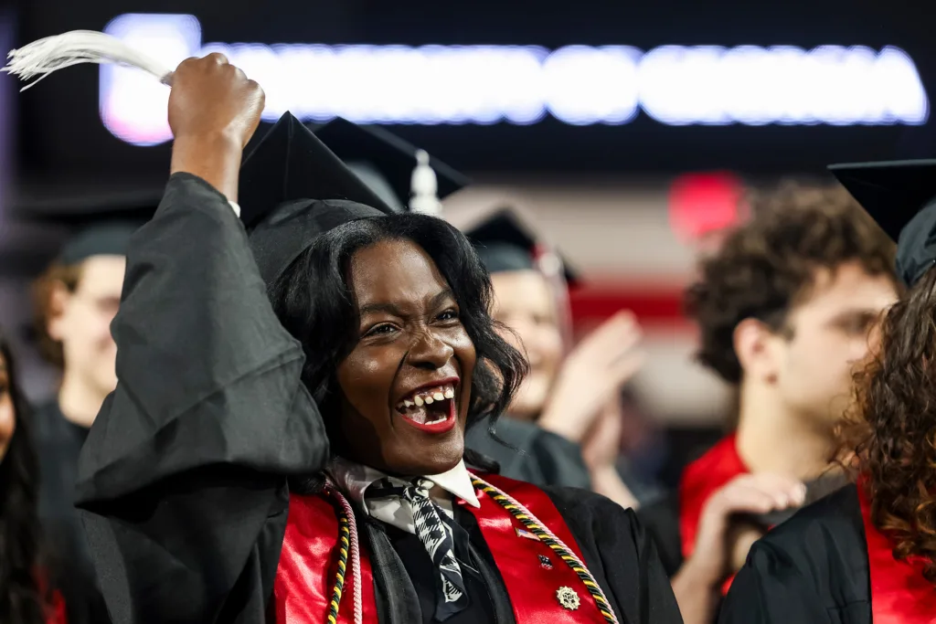 A graduate celebrates during the conferring of degrees during the fall undergraduate Commencement ceremony.