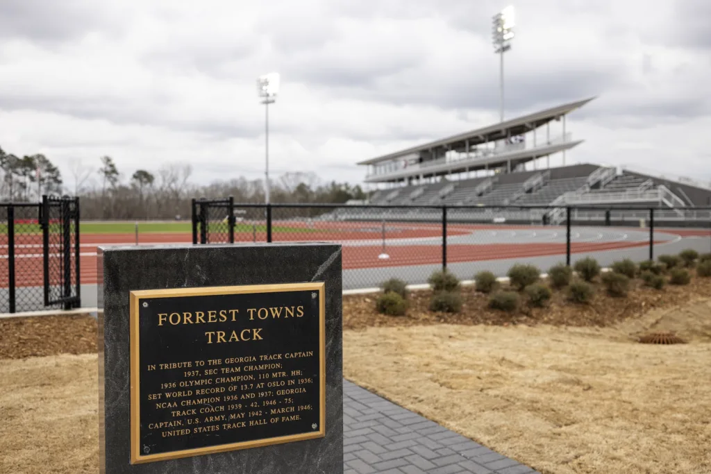 Close-up of informational sign at the Forrest "Spec" Towns track in front of the outdoor track area.