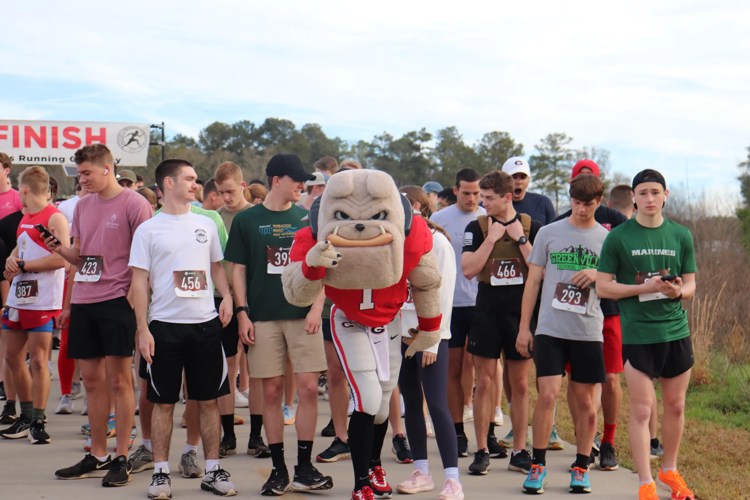 A group of runners start a 5K with Hairy Dawg in the middle.