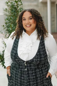 Environmental headshot of a woman standing outside