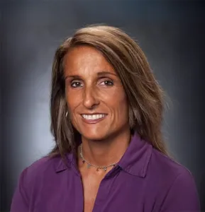 Headshot of a woman against a dark gray background