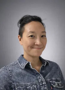 Headshot of a woman against a gray background