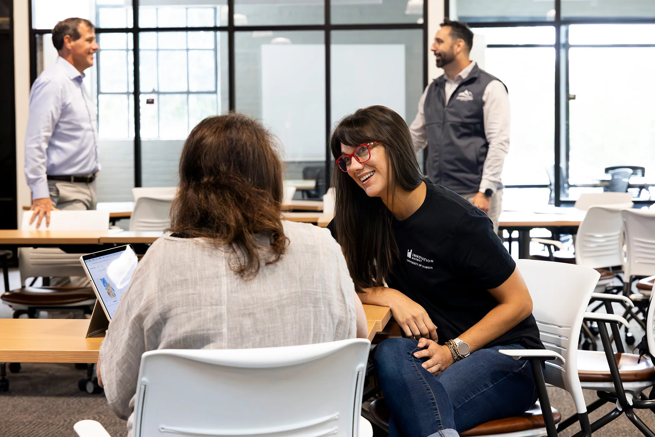 People interact in a bright, modern space during a Faculty Innovation Fellows event at the Innovation Hub.