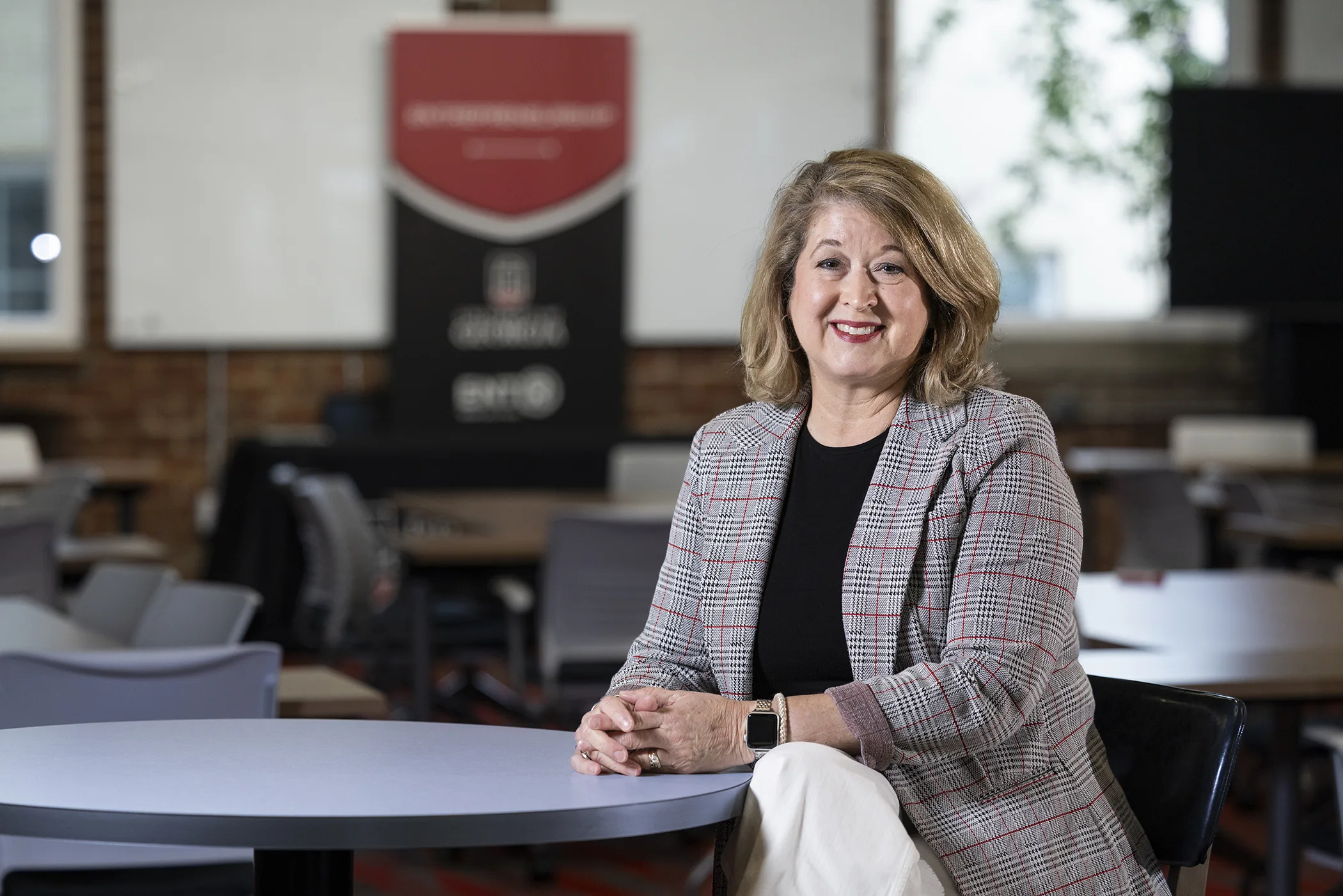 A woman sits at a table in an open space designed for entrepreneurs