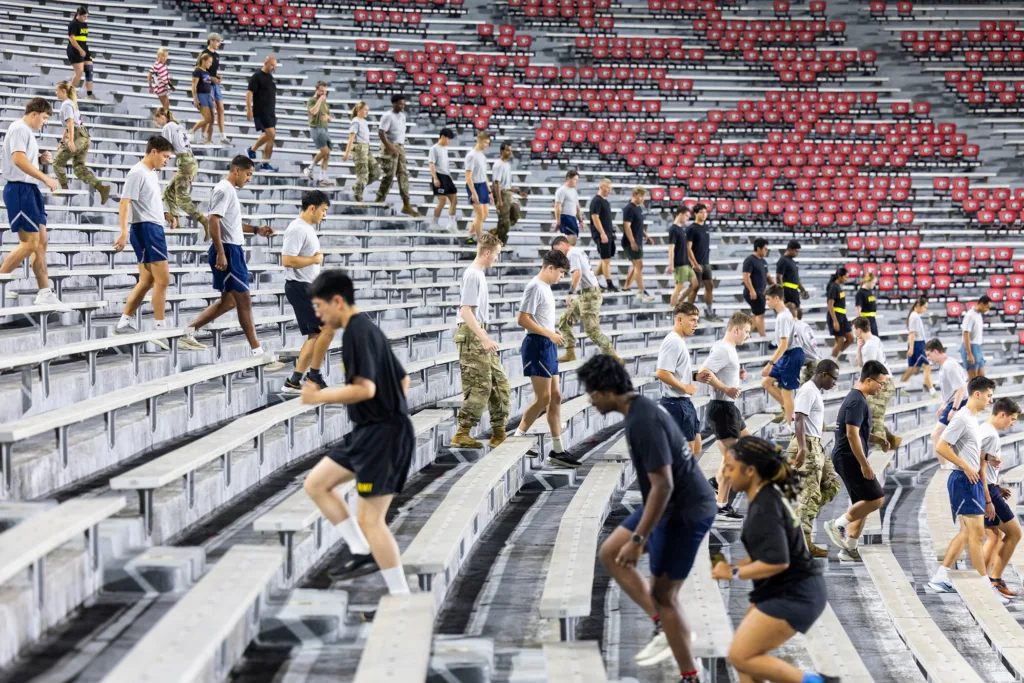 Students and ROTC cadets climb up and down a series of stairs in Sanford Stadium.