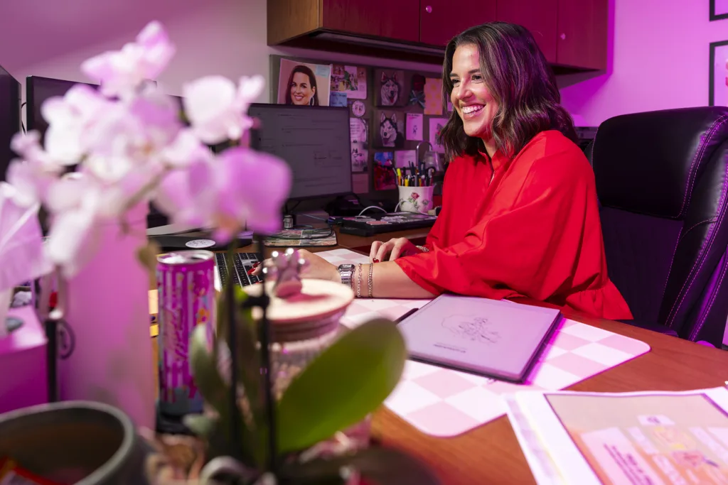 A woman works at a desk in her office working on a computer